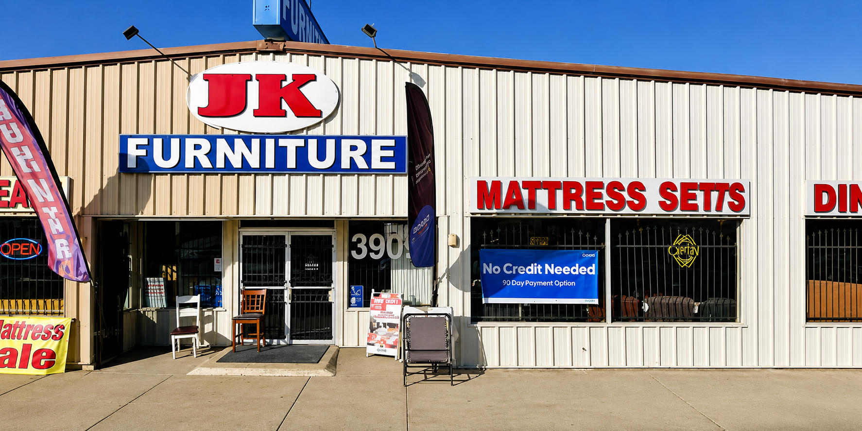 JK Furniture store front with promotional signs for mattress sets and no credit needed.